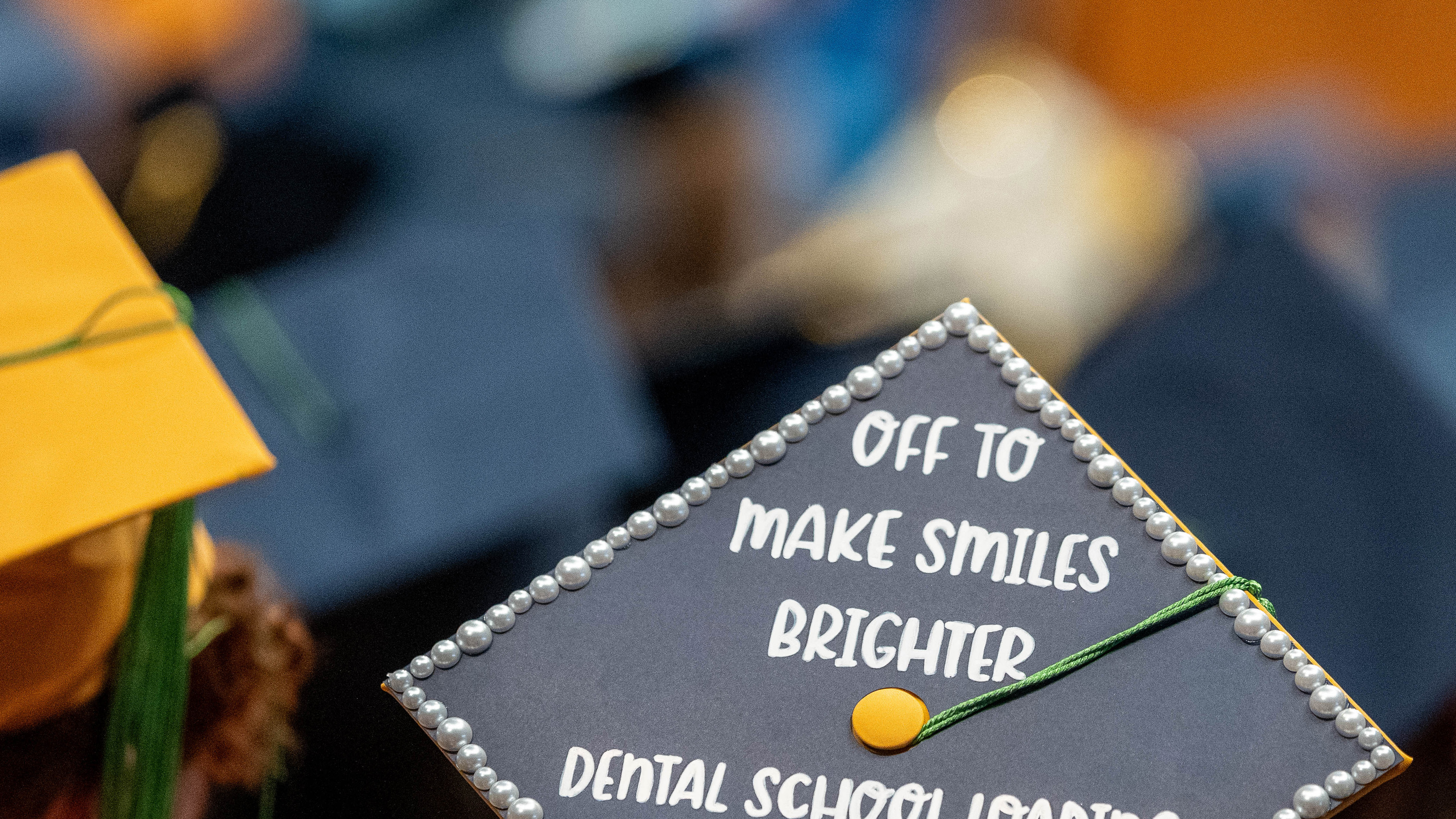 graduation cap with 'off to make smiles brighter' decoration