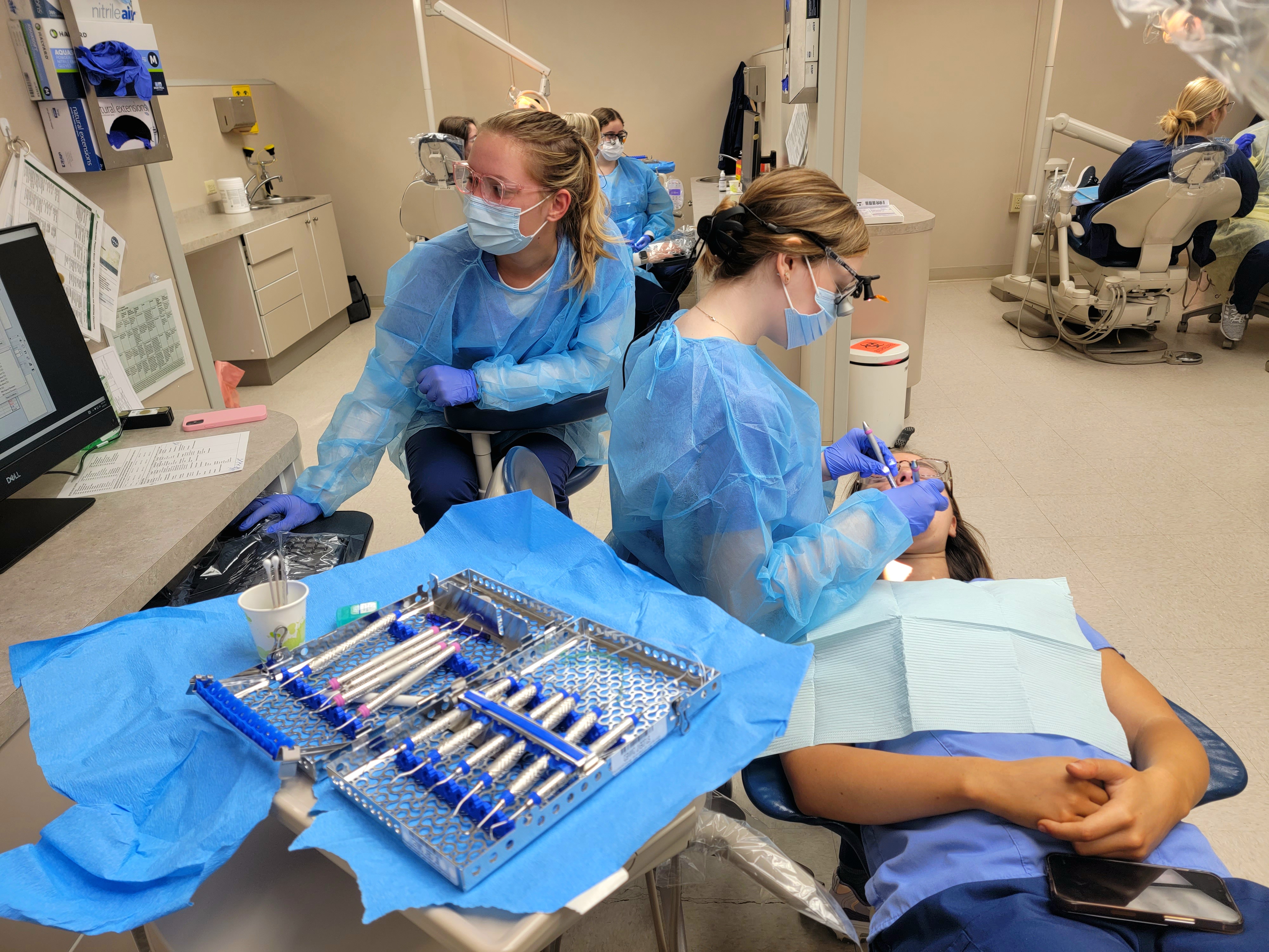 Dental hygiene students work together in an initial assessment clinic. 